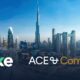 Dubai skyline with Burj Khalifa centered, featuring Stake x ACE & Company partnership branding over city skyscrapers and highways.